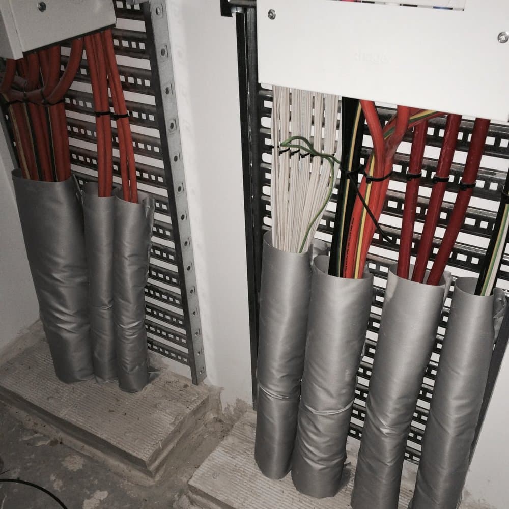 Cables re-sealed in fire-rated wrap sleeves after rectification.
