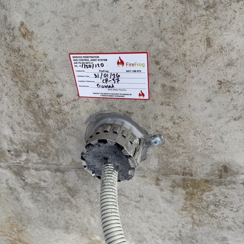 An installation label on a completed collar, recording the installer, date and tested system.