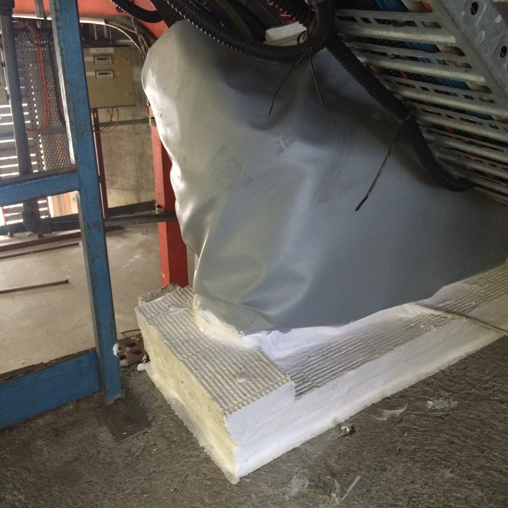 A fire barrier installed over a cable tray, viewed from scaffold.